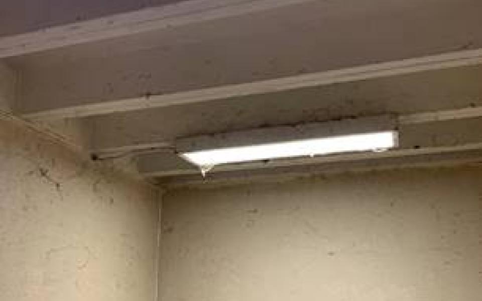 Photos taken by Rep. Jason Crow of poor conditions during post tour, including broken chairs in a classroom and occupied soldier housing