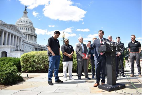 Crow standing with SIV Interpreters 