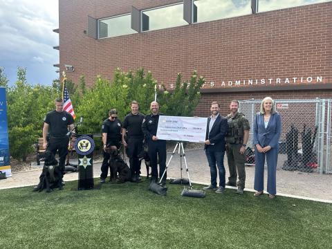 Rep. Crow with Democratic Whip Katherine Clark (MA-05), Arapahoe County Sheriff Tyler Brown, Head of the K9 Unit Sgt. Brian Starbuck, K9 unit members, and department dogs. 